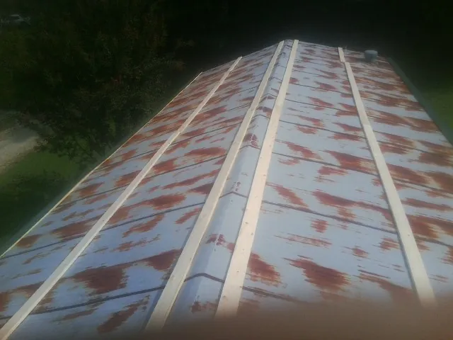 Rusted metal roof panels with new wood purlins before replacement — Storm Damage Roof Repair in Gnadenhutten by Roofing Brothers